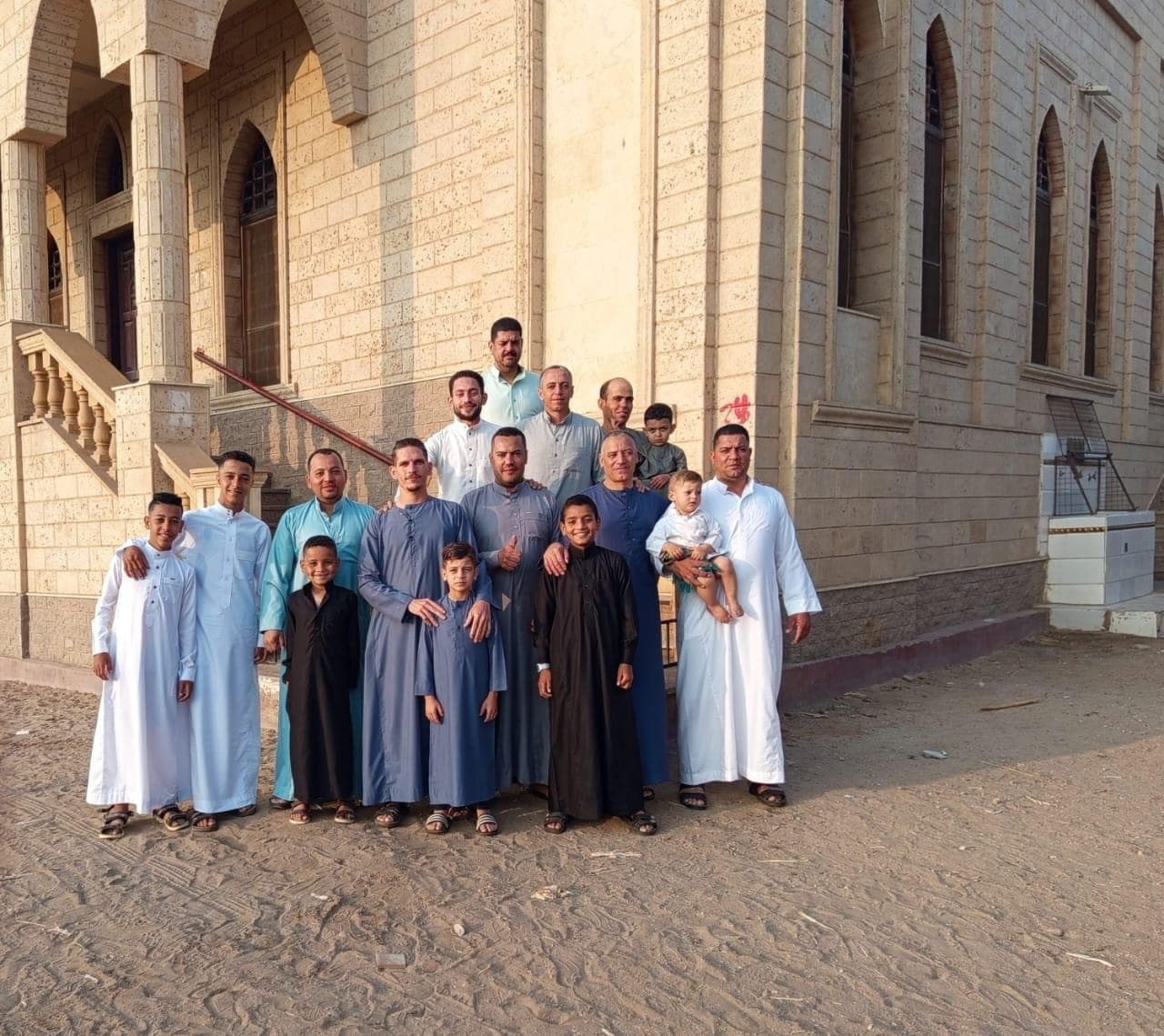 The site team gathered outside Almaghfera Masjid alongside the finished stone elevation