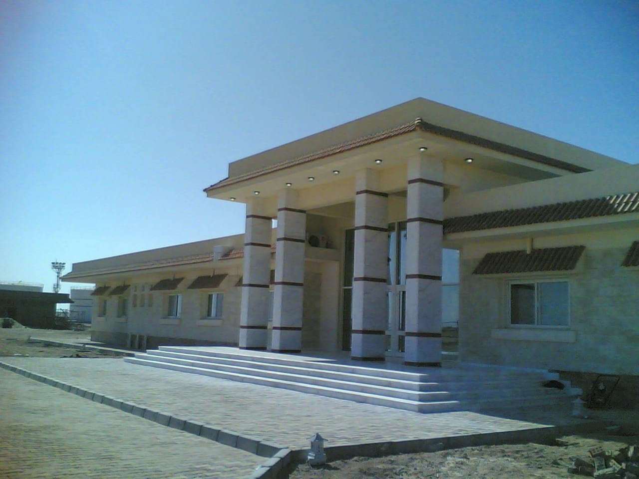 Esh Almalaha — stone-clad elevations under a tiled roof