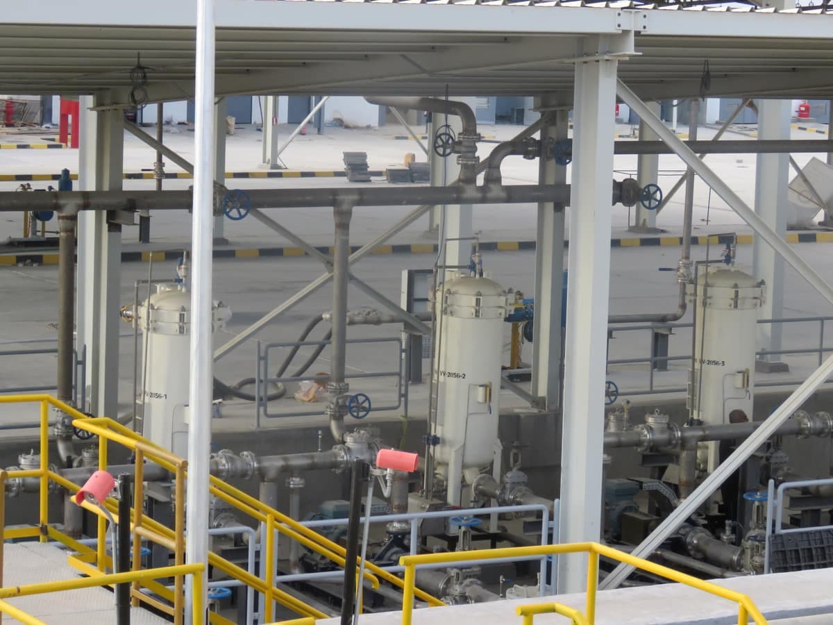 An array of filter vessels beneath the steel structure at the Al-Alamein depot