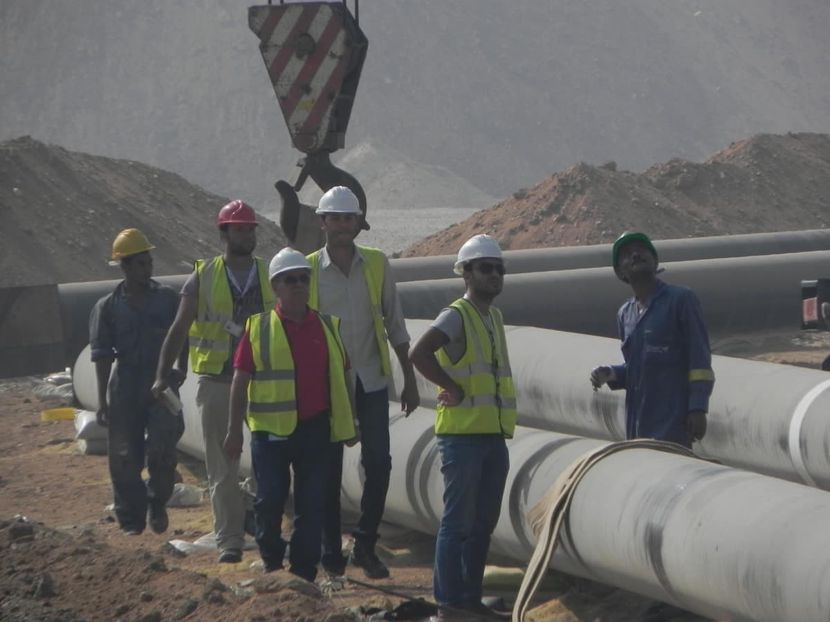 The Al Majd · Warner Lewis site team beside a section of hydrant main