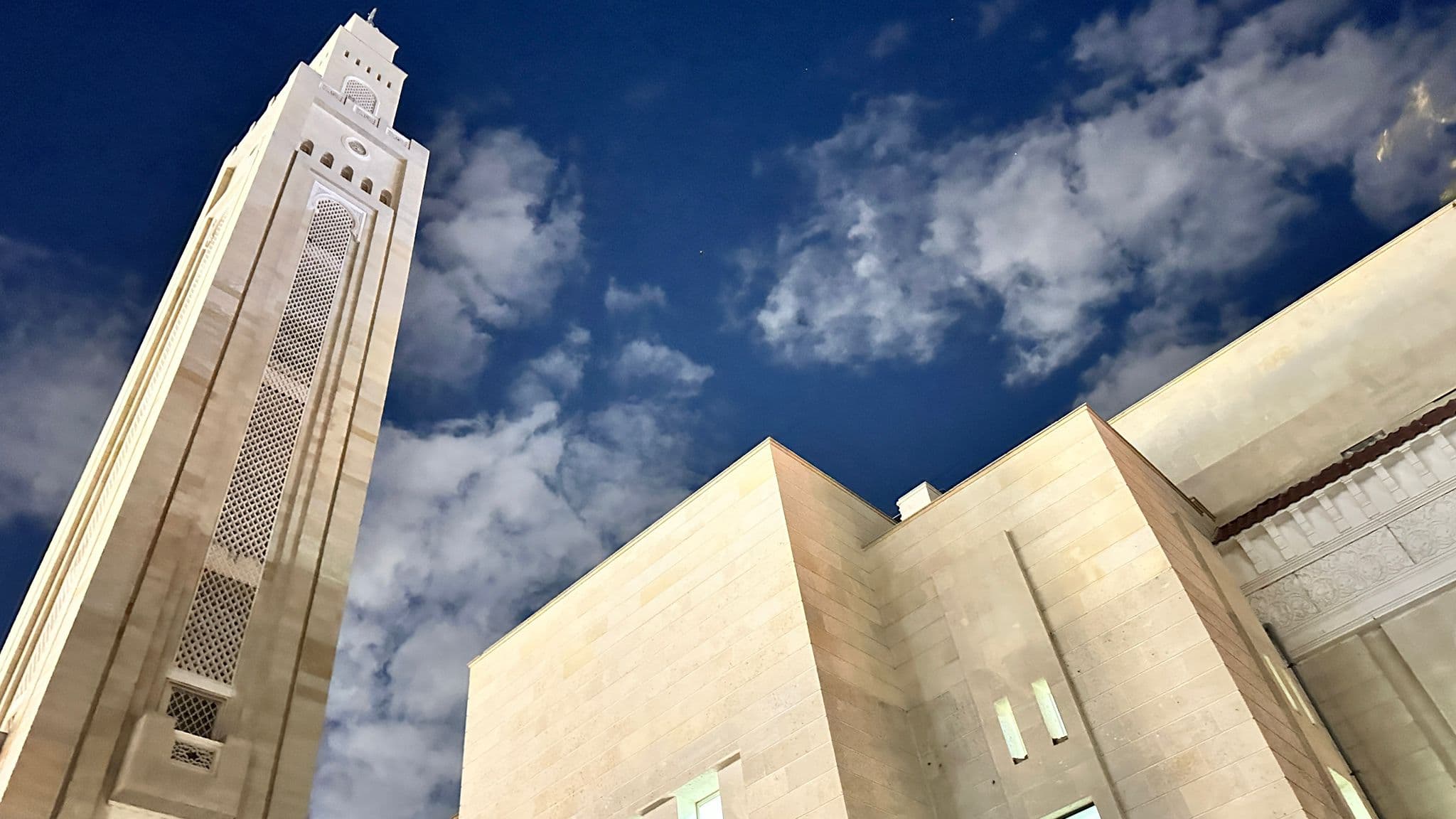 The minaret and stone facade against the sky