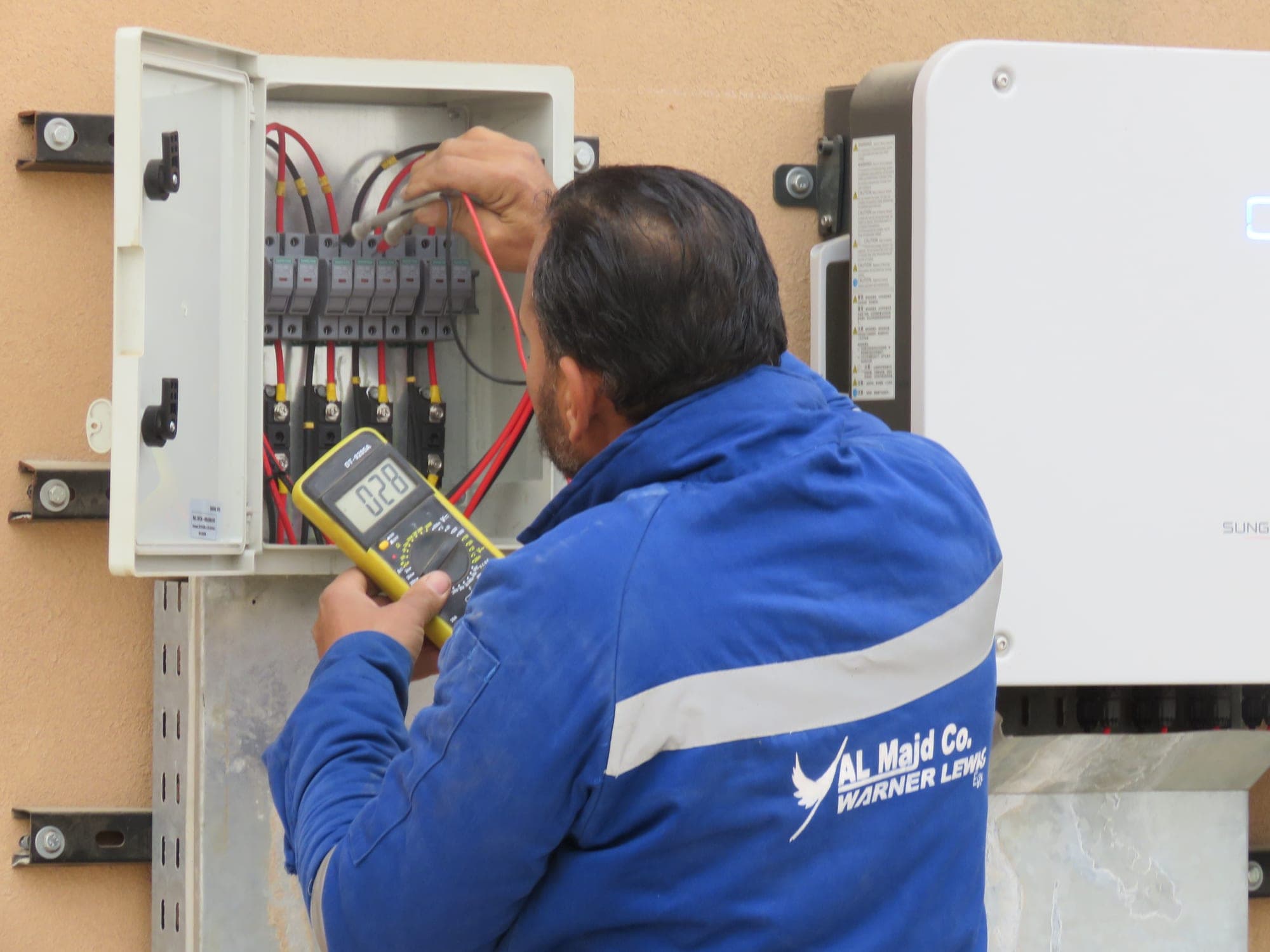 Al Majd · Warner Lewis engineer testing an electrical distribution board on site
