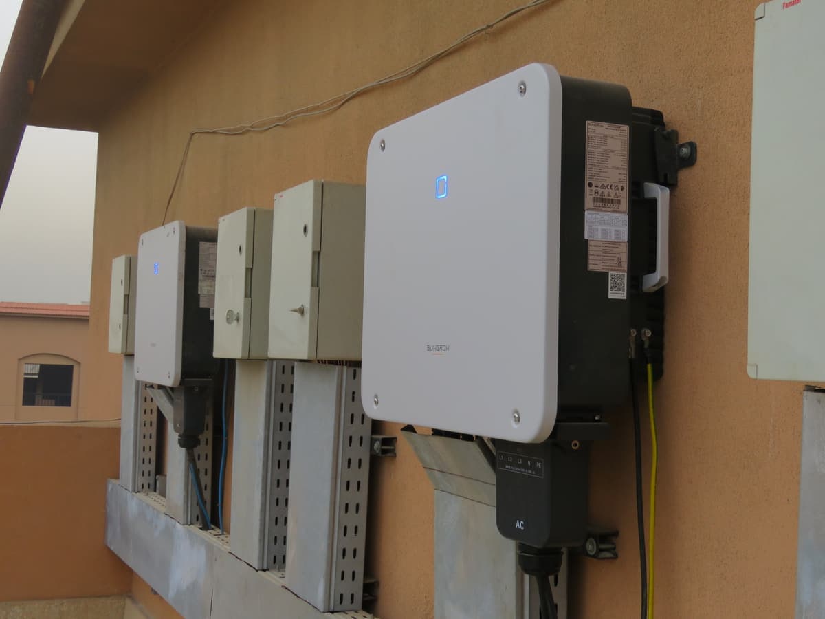 Wall-mounted string inverters and cable trays at Al-Andalus International School